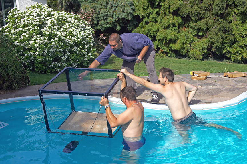 The perspex tank being carried into the pool